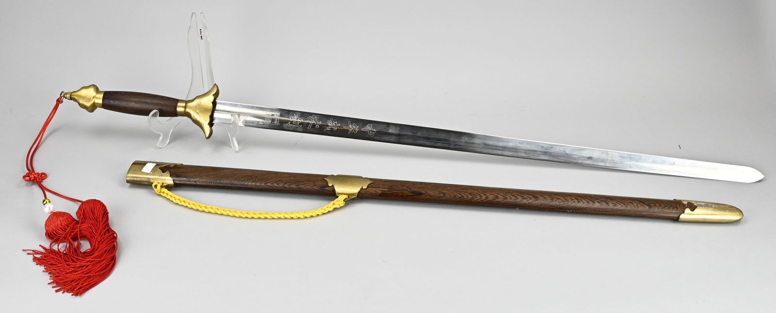 Decorative sword: Copy of a Chinese traditional sword. Hardwood with brass. 21st century. Dimensions: L 102 cm. In good condition.