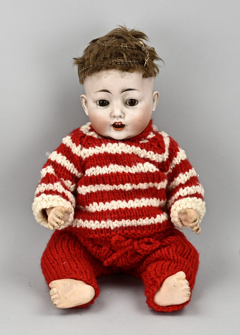 Antique porcelain character doll: Antique porcelain character doll. Circa 1920. Marked no. 36, 99/6, Made in Germany. With real hair, baby body and sleep eyes. Size: 35 cm. In good condition.