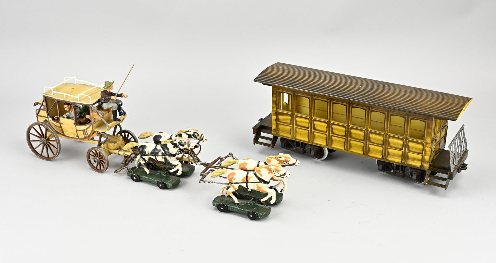 Elastolin stagecoach + wagon: Elastolin stagecoach with three cowboys. Germany. Circa 1930. 1940. Size: 40 cm. In good condition. Elastolin train wagon made of bakelite. Germany. Circa 1940. One gate loose. Size: 31 cm. In