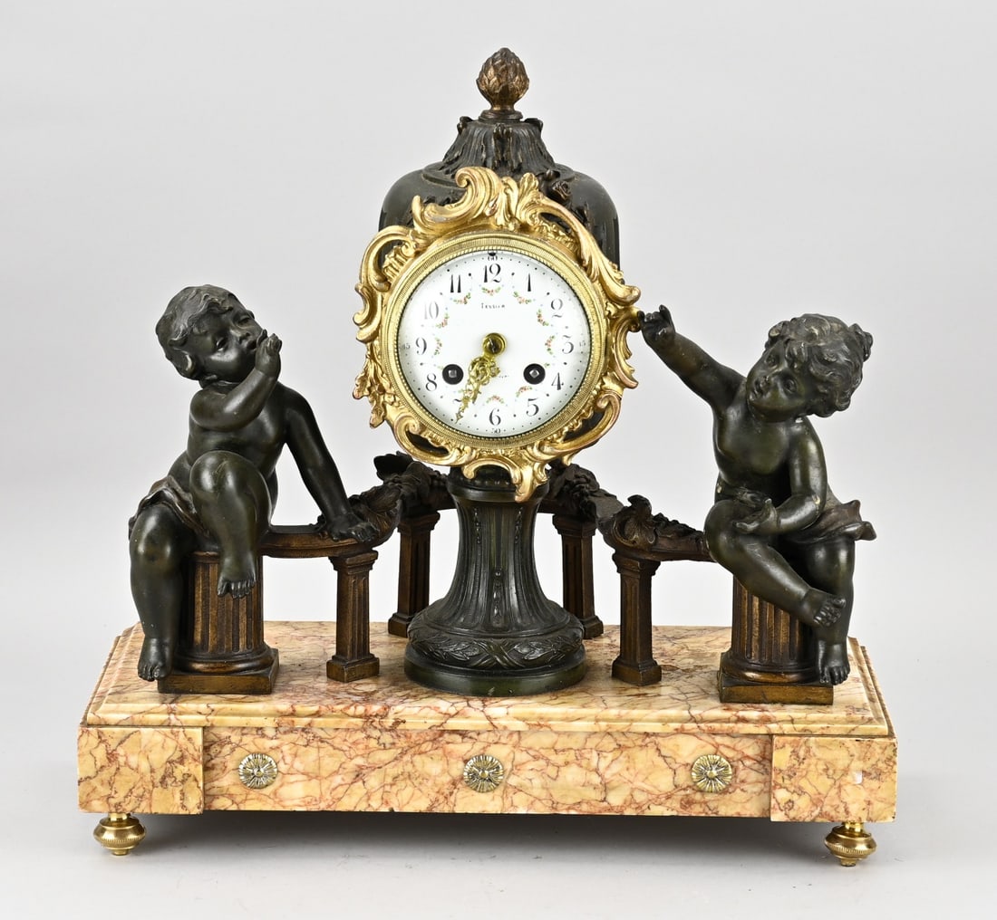 French pendulum clock, 1900: Antique French marble mantel clock with putti, composition metal. Circa 1900. Eight-day movement, half-hourly striking. Size: 40 cm. In good condition.