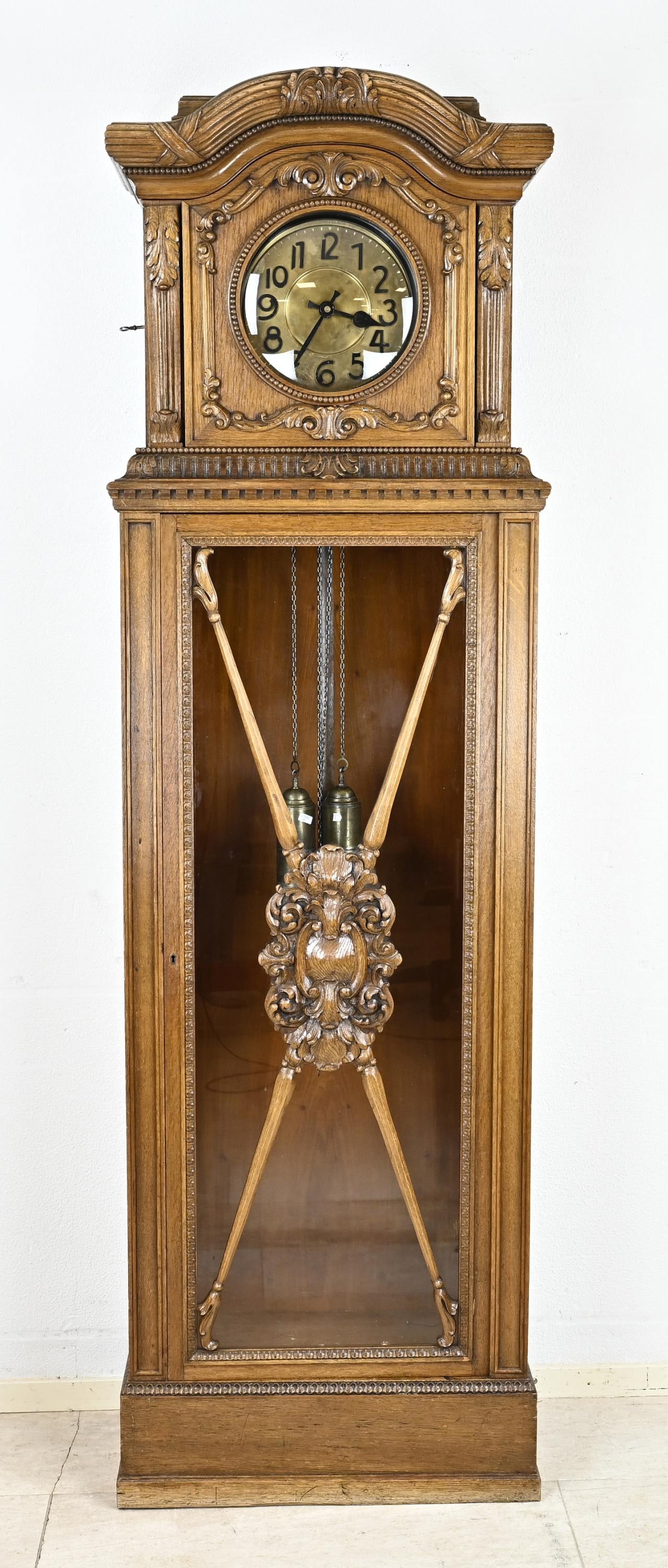 Standing clock, H 217 cm.: Antique oak standing clock with carving. Germany. Circa 1930. Only numbered. Weekly runner with half-hourly striking. Dimensions: H 217 cm. In good condition.