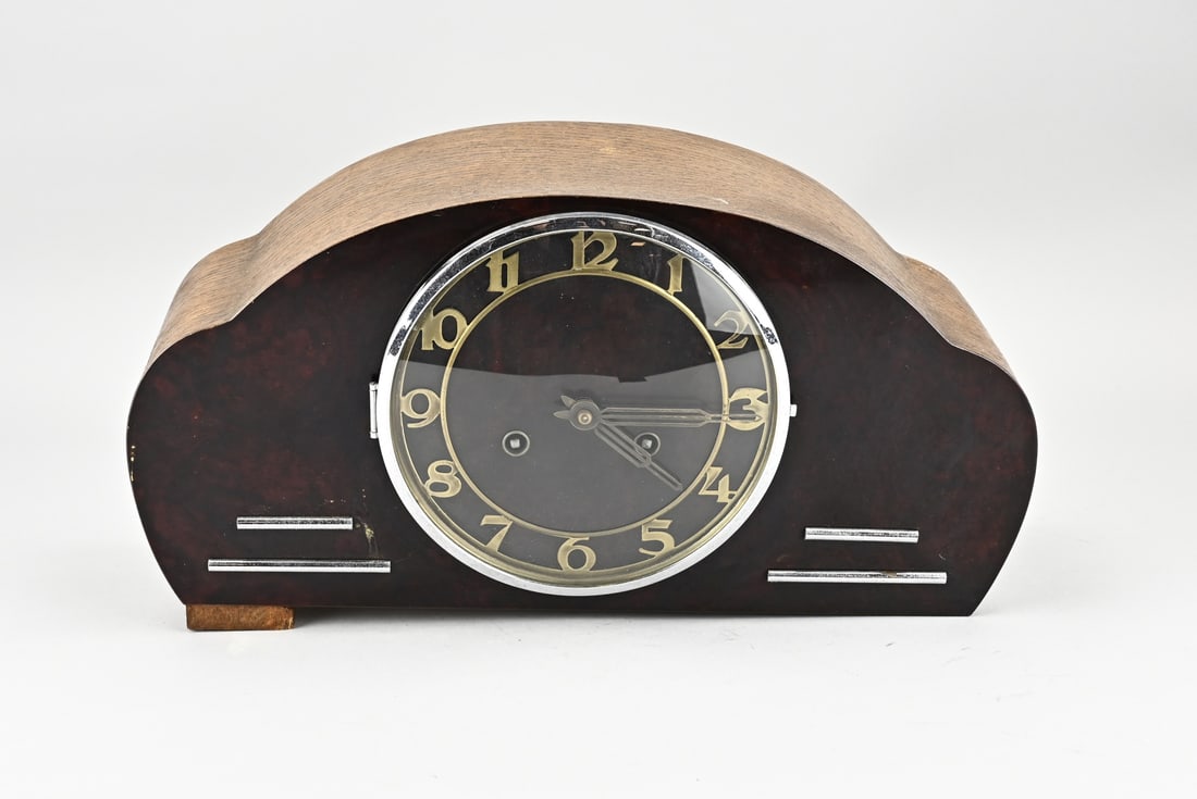 Table clock, 1930: Art Deco table clock. Oak, ebonised + chrome. Circa 1930. Half-hourly strike with three gong rods. Dimensions: 20 x 39 x 13 cm. In good condition.