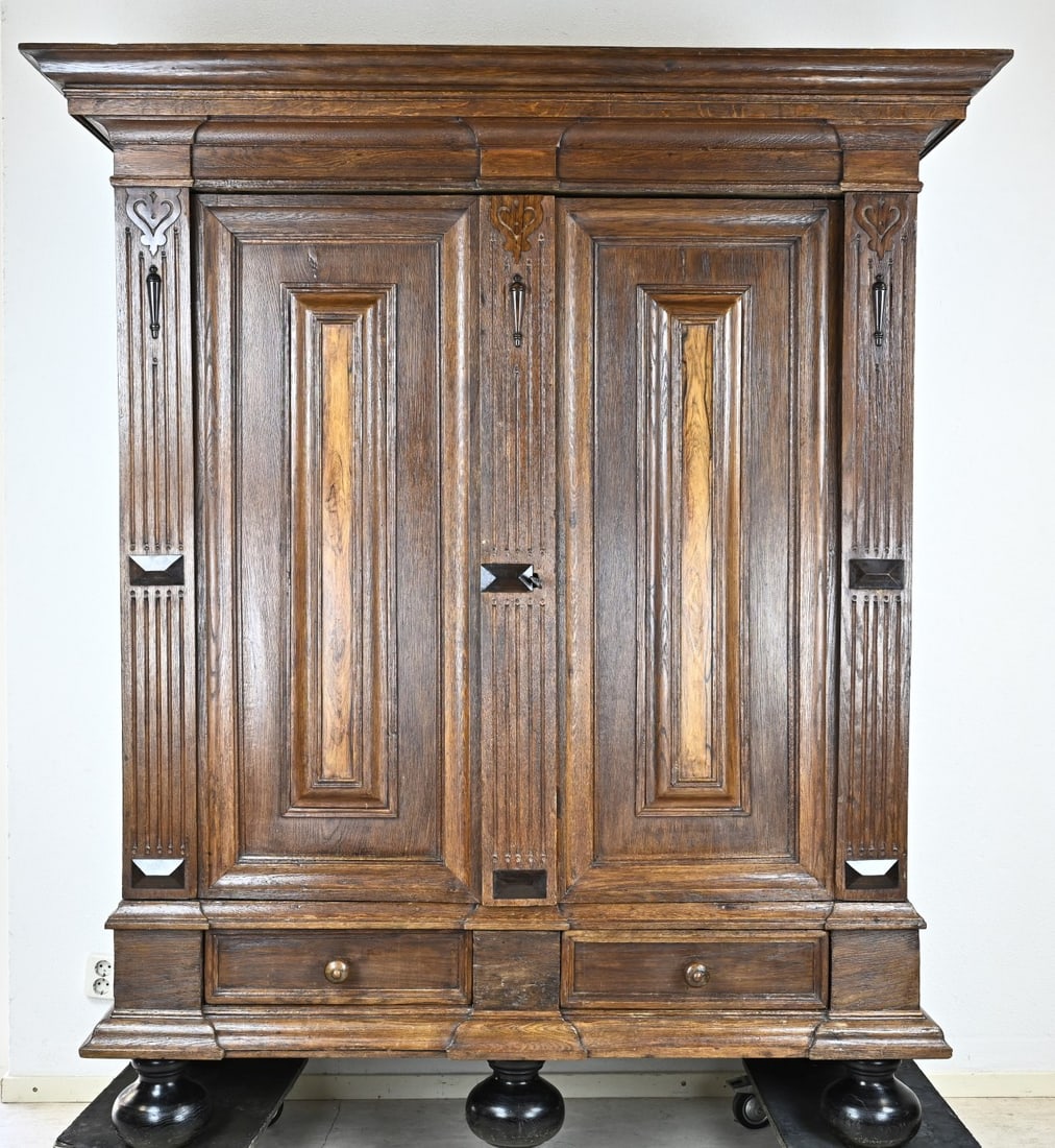 Oak cushion cabinet: Dutch 18th century oak cushion cabinet, standing on black ball feet with 2 drawers above. Sides decorated with ebony ornaments. Two doors with rosewood veneer and original lock. 202x176x57cm. In good