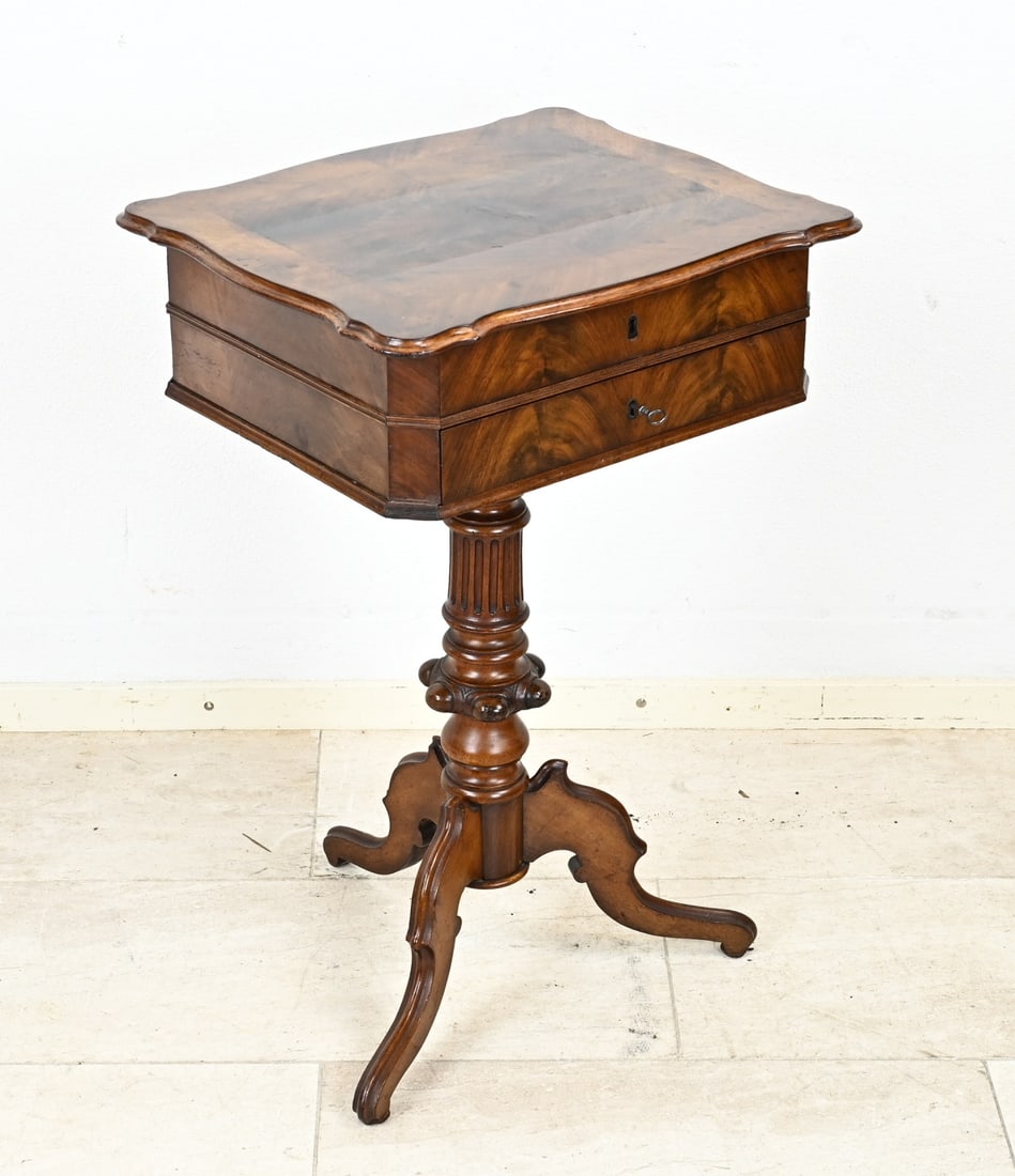Mahogany sewing/side table, 1870: Mahogany sewing/side table. Standing entirely on 3-truss column leg. Circa 1870. First drawer has various compartments and a folding top. Table has recently been completely restored and polished.