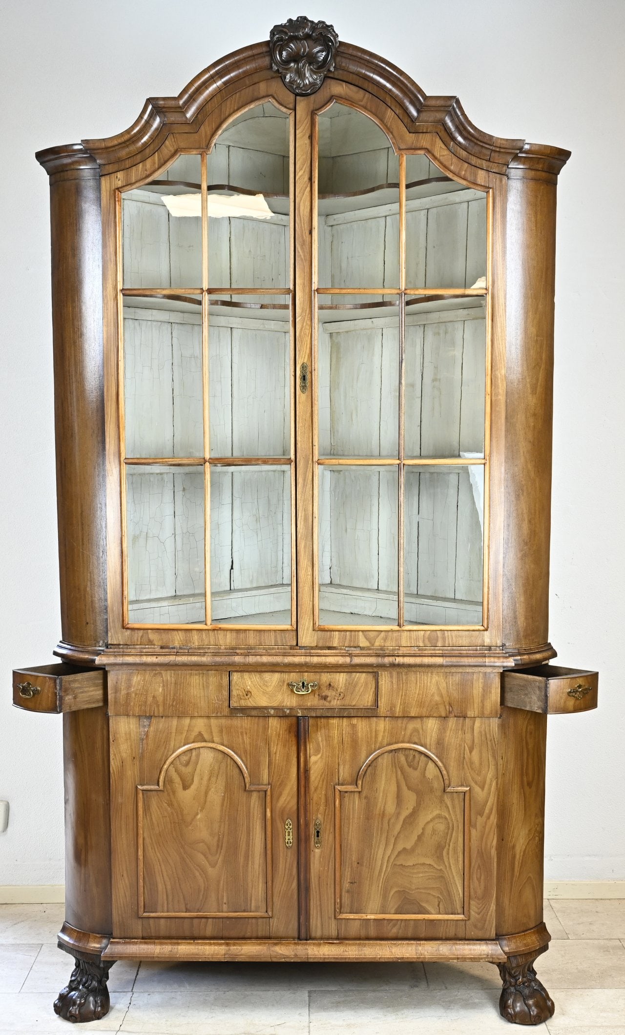 18th century mahogany corner cupboard: 18th Century Dutch mahogany Baroque porcelain corner cabinet. Two-piece, with three drawers, four doors and claw feet. Dimensions: 245 x 135 x 80 cm. In good unrestored condition.