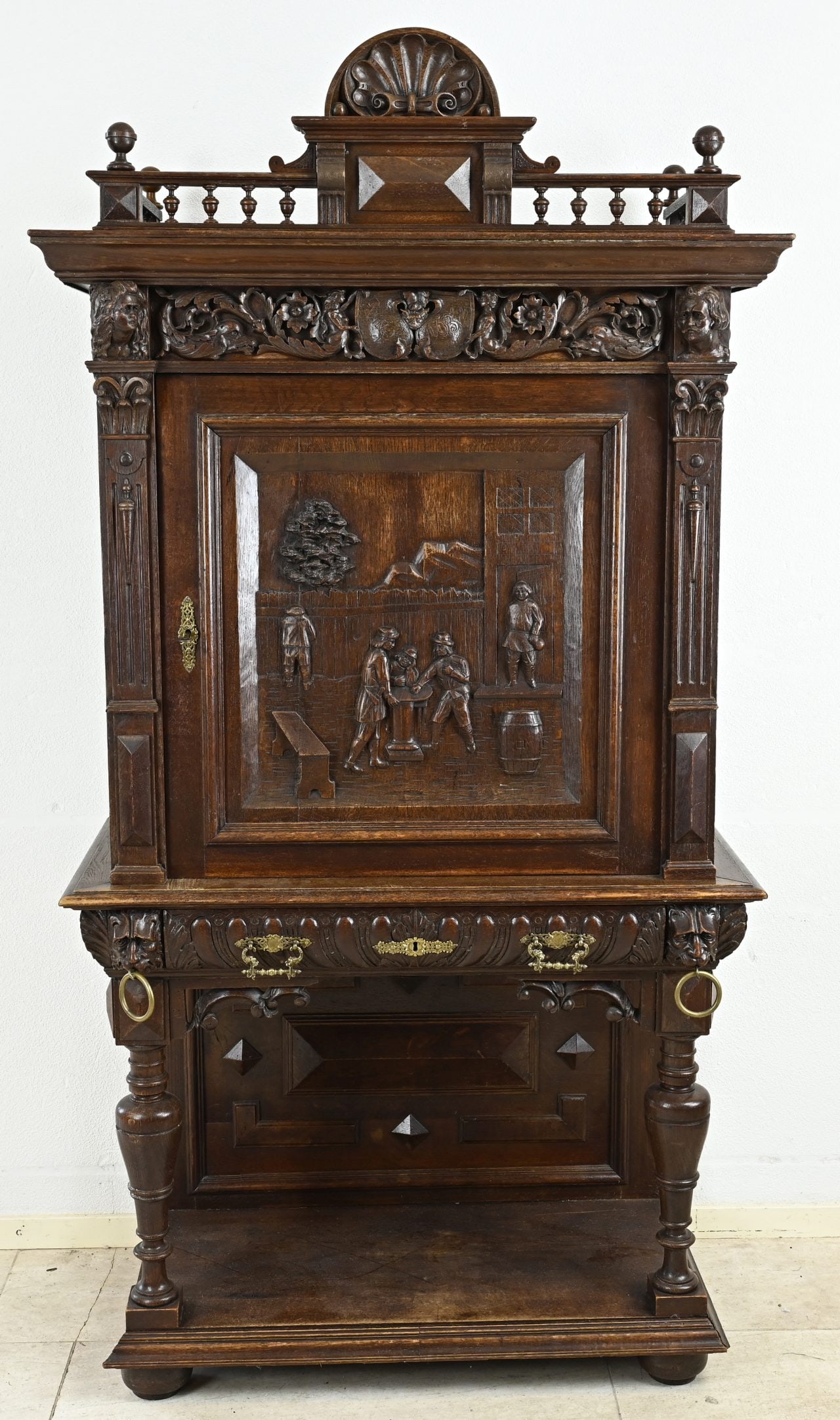 Oak cabinet with carvings: Special 1-door oak historicism top cabinet with drawer, putti, figures, tendrils and lion heads decoration. Circa 1880. Dimensions: 189 x 101 x 50 cm. In good condition.