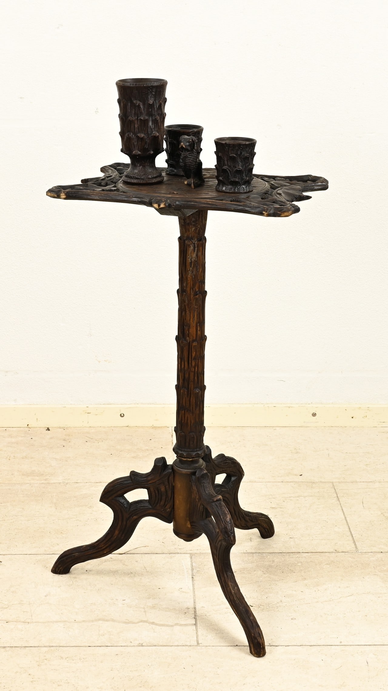 Black Forest smoking table, 1900: Antique walnut carved Black Forest smoking table. Circa 1900. Dimensions: 96 x 44 x 30 cm. In good condition.