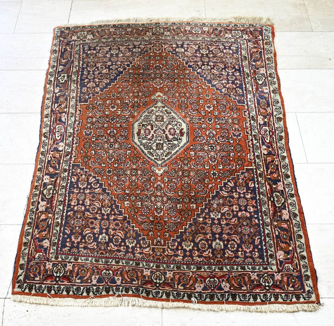 Bidjar carpet, 160 x 120 cm.: Hand-knotted Persian bidjar carpet. Red with blue floral decoration. New price: Hfl. 5,600,- Dimensions: 160 x 120 cm. In good condition.