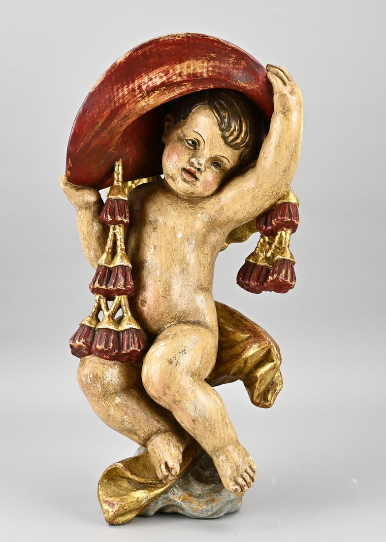 Wooden putti figure: Wooden putti statue. Representing a putti with red hat + decorations with original polychromy. End of the 19th century. Dimensions: 52 x 27 x 18 cm. In good condition.