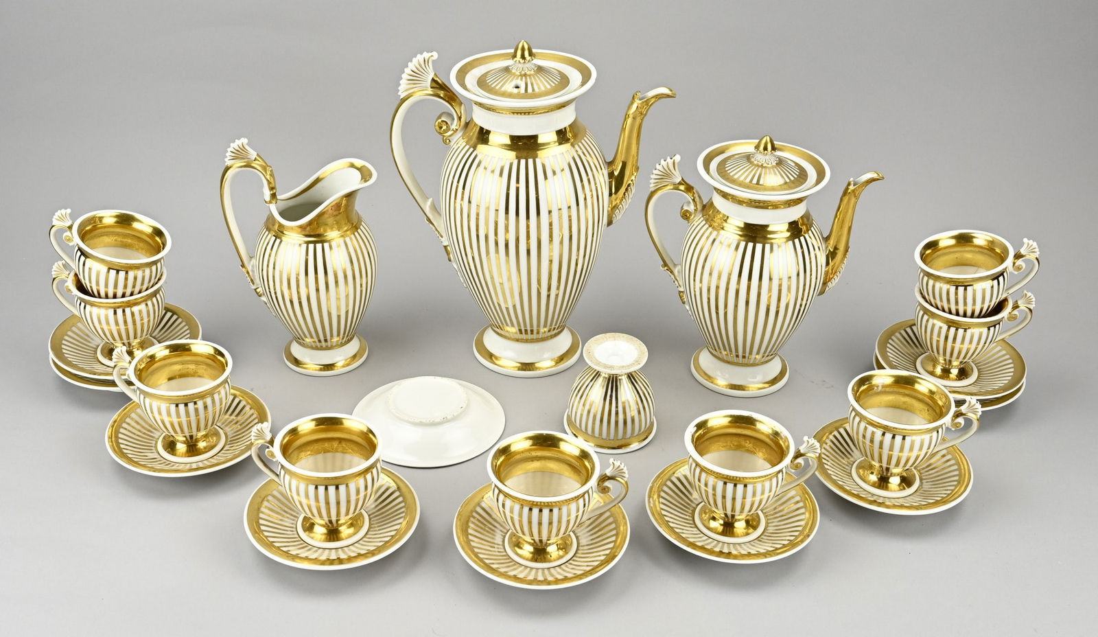 Empire tableware with gilding: Antique porcelain empire service with gilding. 19th century. 13-piece. One cup hairlines. One saucer chip. Size: 7 - 30 cm. In good condition.
