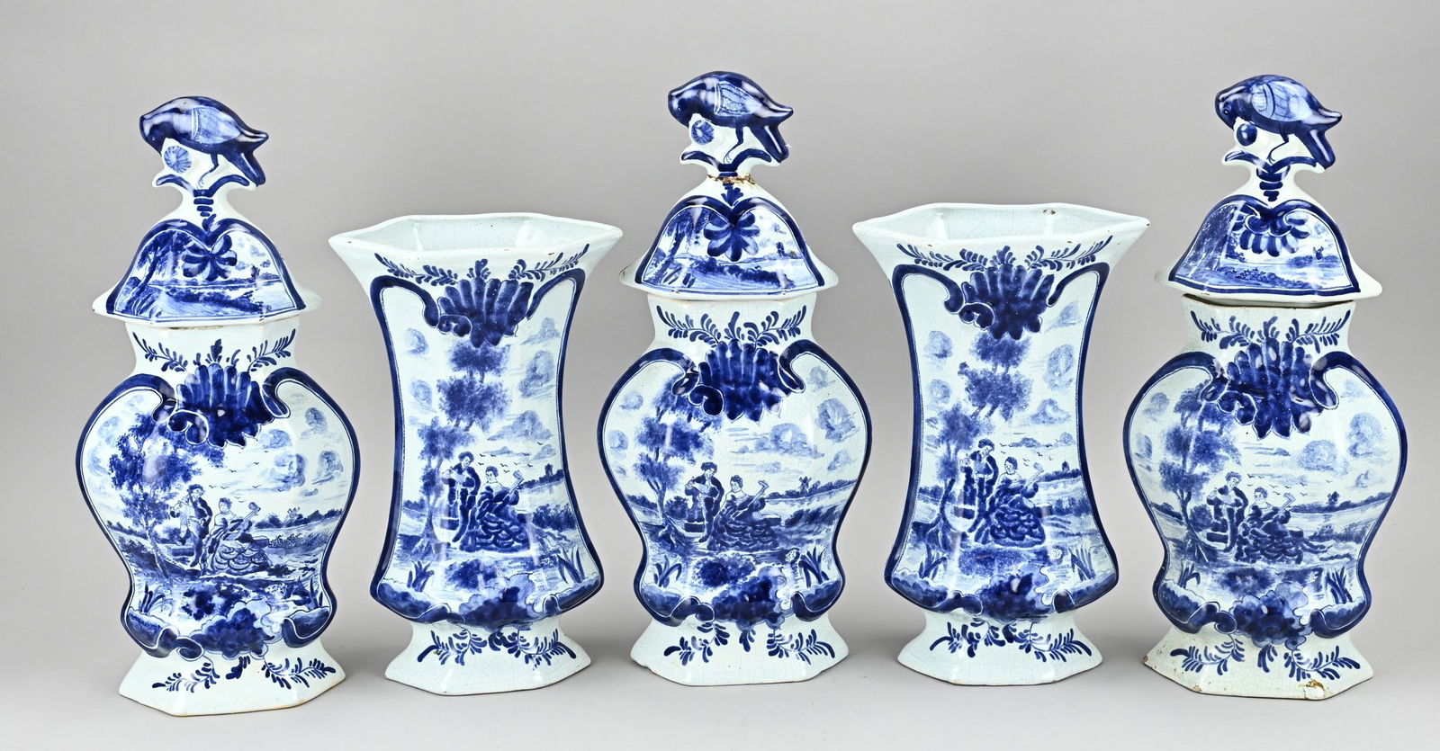 5-piece Delft cabinet set: Antique five-piece Delft faience cabinet set with musical figures in landscape decor. Dimensions: H 30 - 38 cm. In good condition.