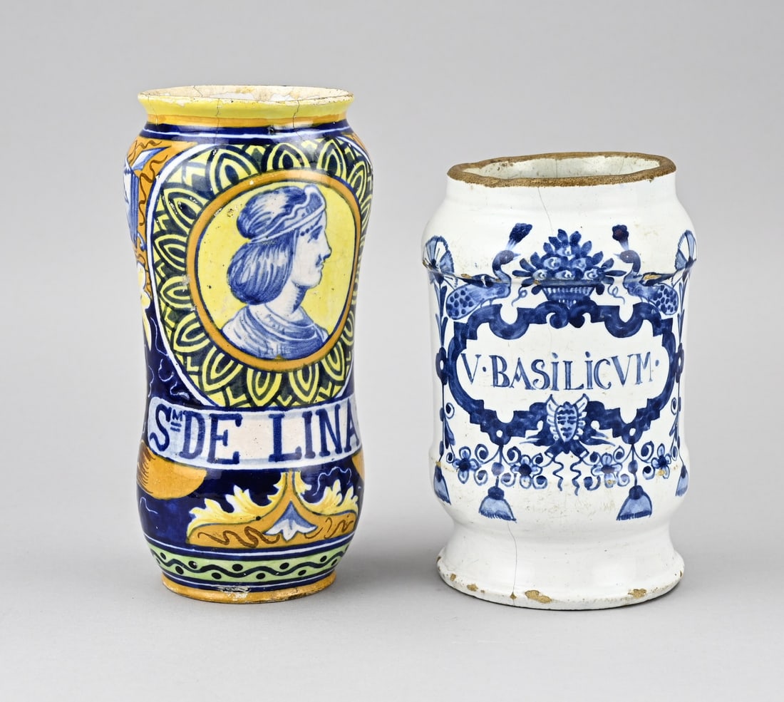 2x Albarello, H 18 - 21 cm.: Two 18th century faience albarello's/apothecary jars. 1x Italy, S. de Lina, polychromy. 1x V. Basilicum, Holland, peacock decor, hairline cracks. Size: H 18 - 21 cm. In reasonable/good condition.