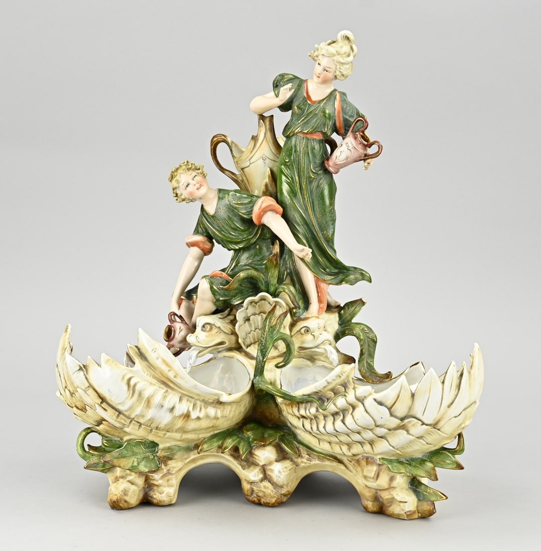 Antique porcelain table piece: Large, antique, Art Nouveau porcelain table piece. Figures/floral and gold. Unmarked. Only fingers damaged. Dimensions: 35 x 33 x 16 cm. In reasonable/good condition.