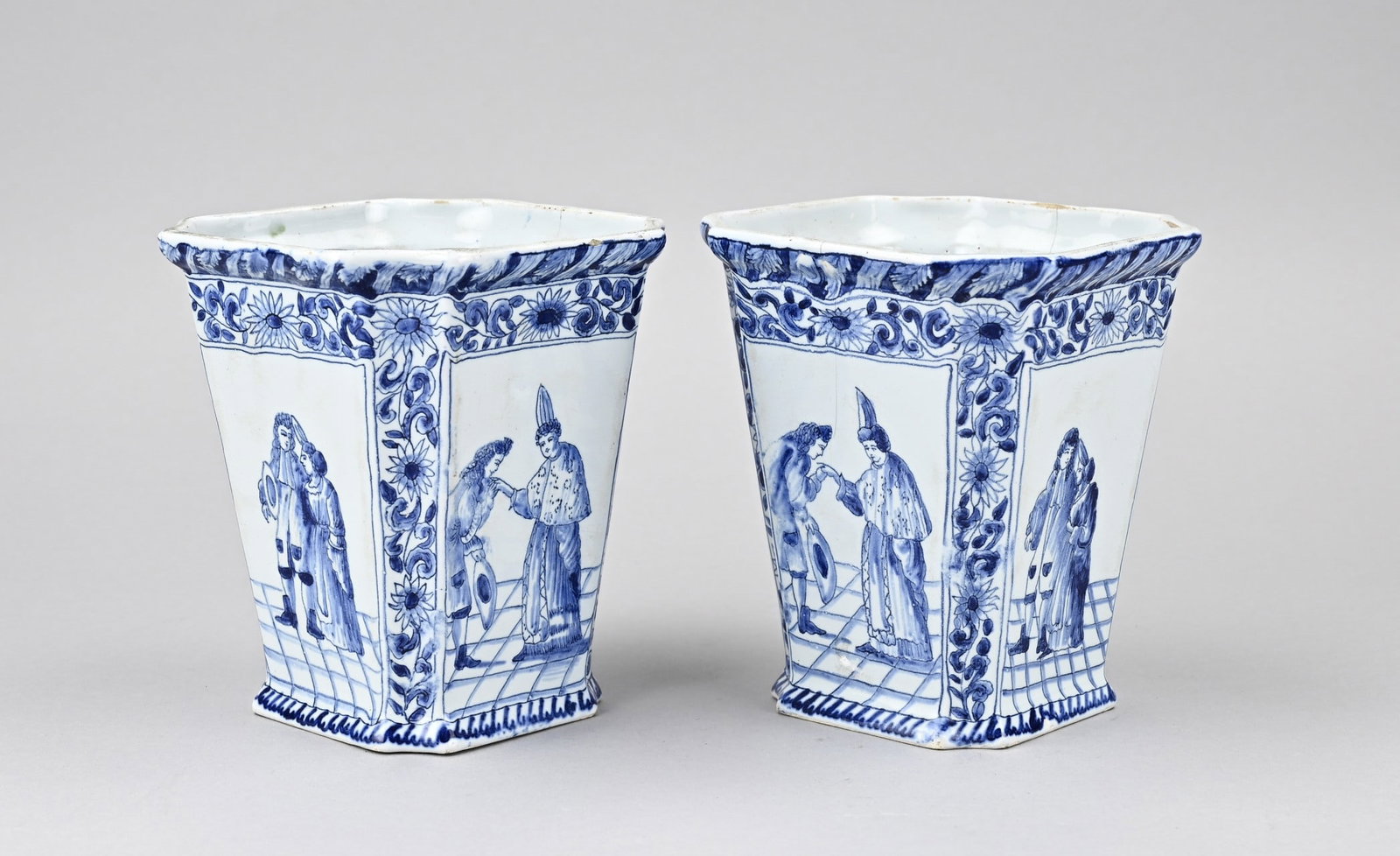 Set of Delft flower pots, 1900: Two antique Delft faience flower pots with figure decoration + bottom mark. Circa 1900. Dimensions: H 14.5 cm. In good condition.
