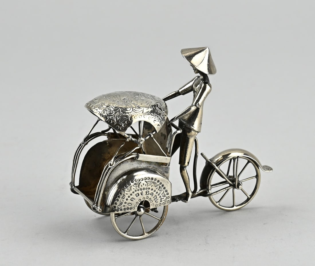 Silver miniature bicycle: Silver miniature, 800/000, in the shape of a bicycle taxi, (betjak/ becak). with figure. The mudguards are marked ORDEBARU". Size 9x5x8.5cm. approx. 62 grams. Rod at parasol loose. In good condition."