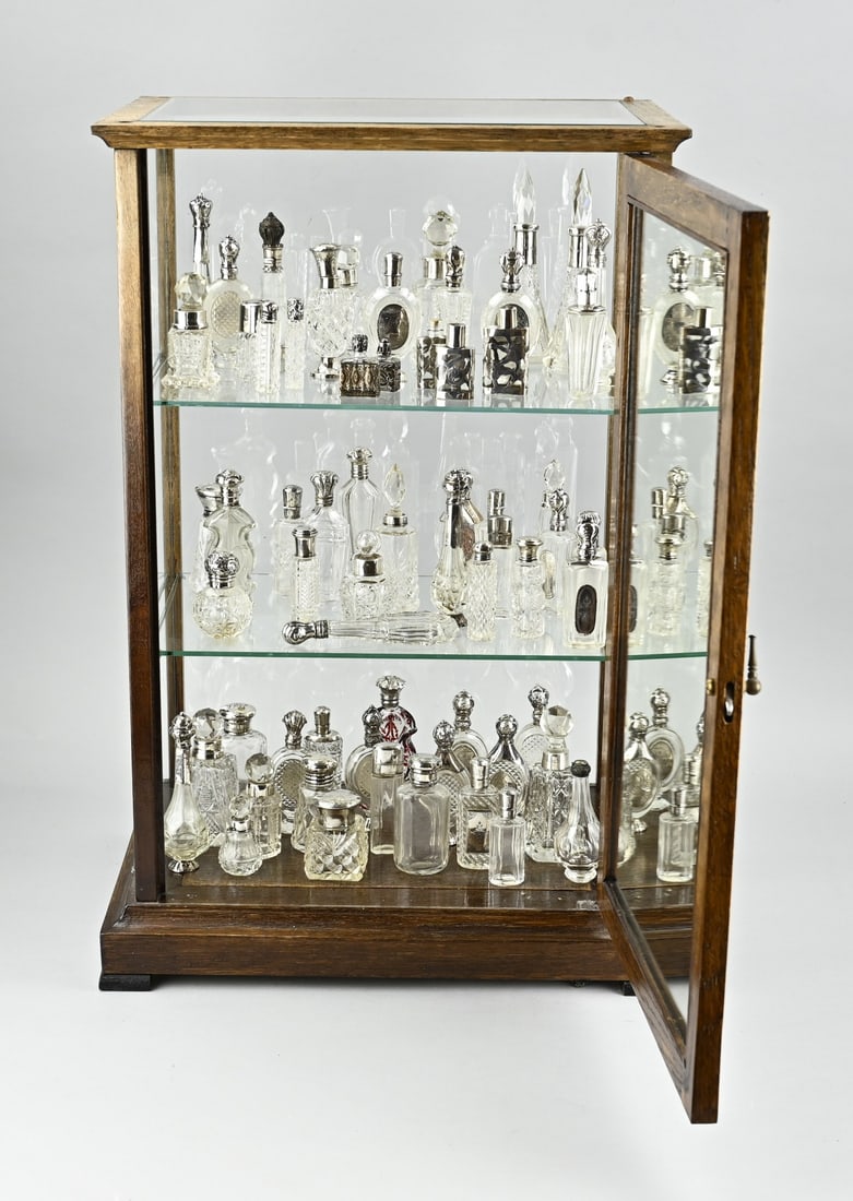 Display cabinet: Display cabinet filled with a large lot of perfume bottles with silver. approx. 60 pieces, various models. various contents. and 2 small plated bottles. Mainly English and Dutch. Most models in very