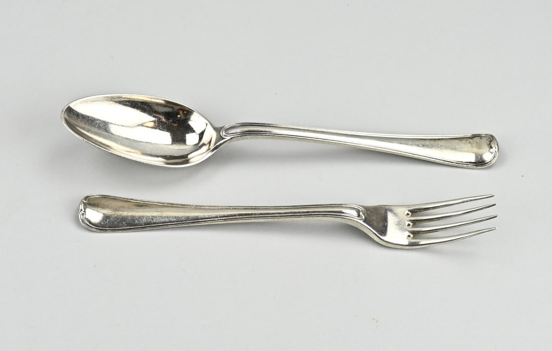 Antique silver cutlery: Antique silver cutlery with a fork and spoon with double fillet. With initials: RK MT.: fork F. Abrahamie, Amsterdam, jl.T:1778. spoon:R.Helweg, Amsterdam, jl.: F:1790. 19.5-21cm. total approx. 146