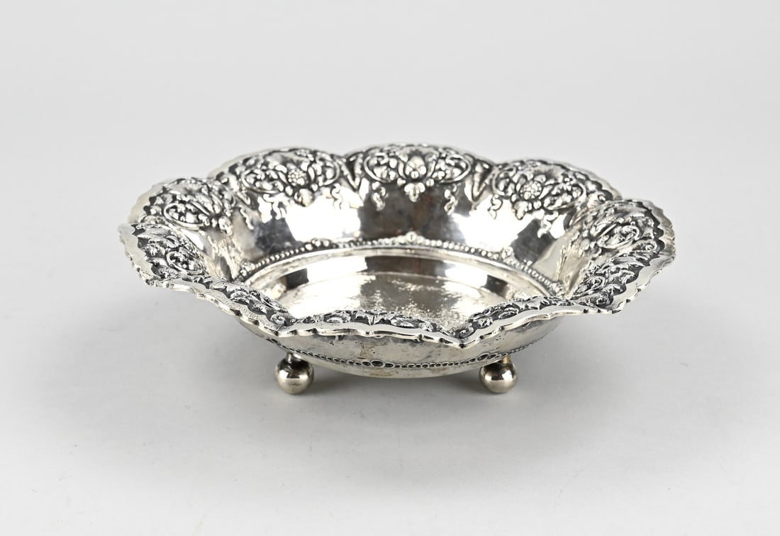Djokja silver bowl: Silver bowl, 800/000, Djokja, with a floral decorated edge and a hammered bottom. The round bowl is placed on 3 ball feet. ø21x5,5cm. approx. 246 grams. In good condition.