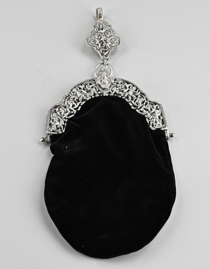 Silver bow bag with skirt hook: Bag with a silver bracket and skirt hook, 833/000, half round bracket with Biedermeier pattern with figures. The bracket has a twisted edge and is provided with a matching contoured skirt hook