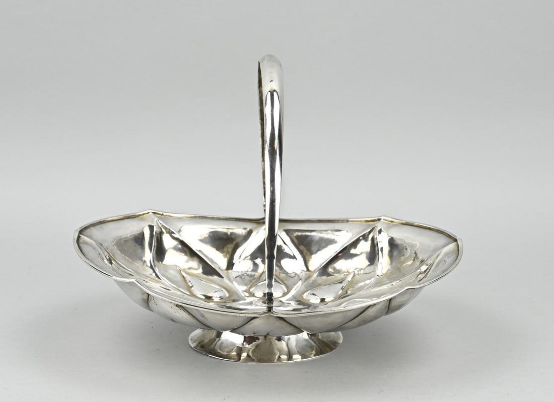Silver basket: Silver handle basket, 84 zolotniks, oval bowl with lobed pear-shaped work. Placed on an oval foot. The bowl is provided with a smooth round handle. marked Moscow, 1866. AWW approx. 504 grams.