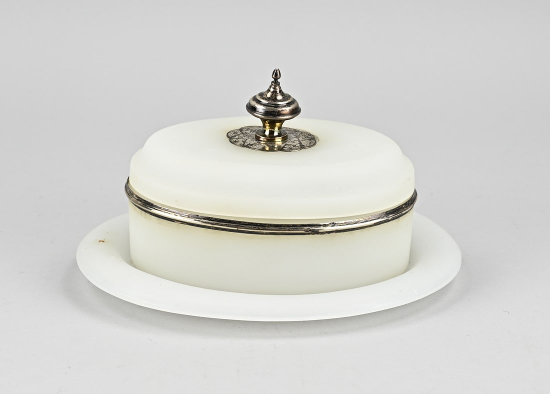 Opaline lidded dish with silver knob: Opaline lidded dish with underplate with a silver rim and a silver knob, 833/000. Oval lidded dish with a silver rim and a lid with silver element and a silver knob with engraving. 22x17x13 cm. In