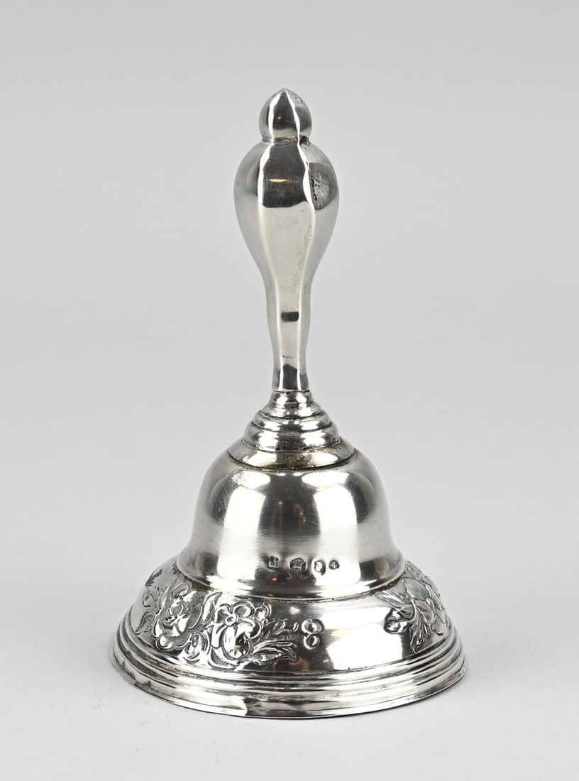 Silver table bell: Silver table bell, 833/000, with a round bell decorated with floral decoration. MT.: CEHeld, Amsterdam, jl.: b:1861. Bell a bit out of shape and handle slightly dented. ø9x15cm. approx. 45 grams. In