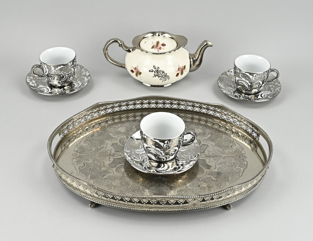 Dishes on tray: Plated tray with plated porcelain tableware. 20th century. Size: 7 - 40 cm. In good condition.