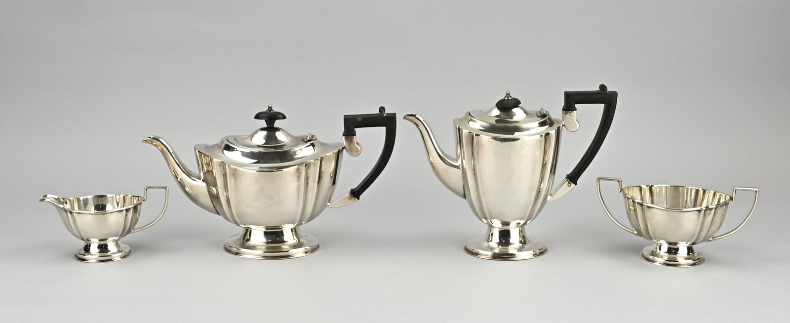 4-piece plated coffee set: Plated coffee set, 4 pieces, oval model with pleats, placed on an oval base with a wooden handle and cup. With a coffee pot, tea pot, milk jug and a sugar bowl. Height 7.5x18.5cm. Marked: