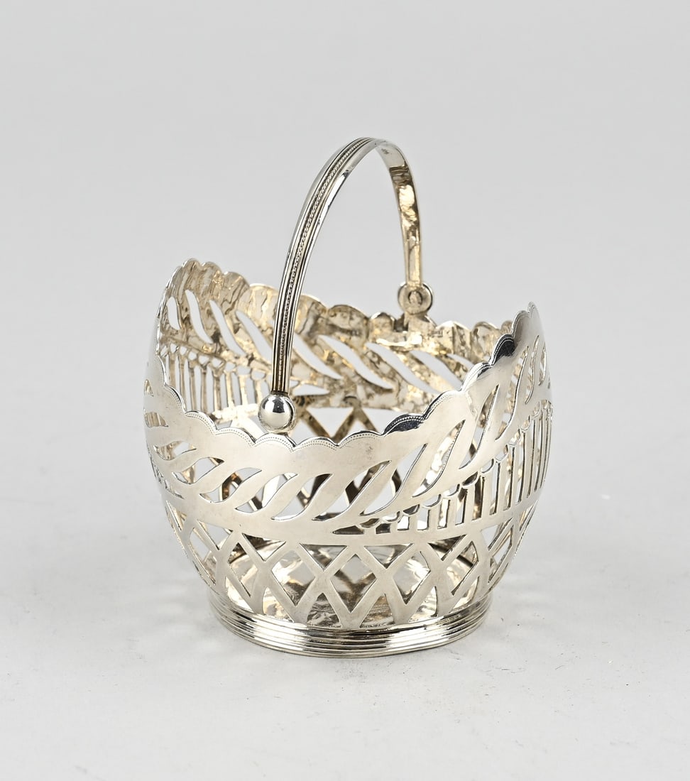 Silver ball holder: Silver ball basket, 833/000, round model with a contoured edge. The basket is decorated with sawn work with, among other things, bars and diamond decoration. Placed on a round ring with double file