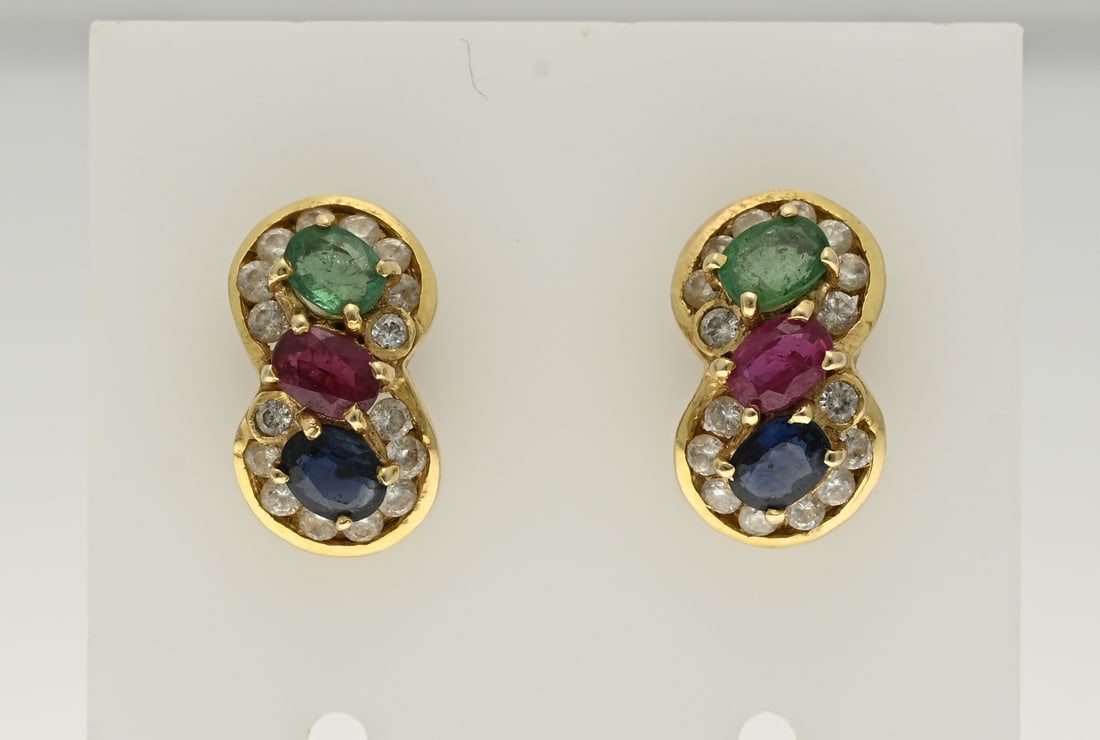 Gold stud earrings with ruby, sapphire and emerald.: Yellow gold stud earrings, 585/000, with ruby, emerald and sapphire. Stud earrings, 8-shaped, set with a round faceted ruby, sapphire and emerald, decorated with a border with small zirconia stones.