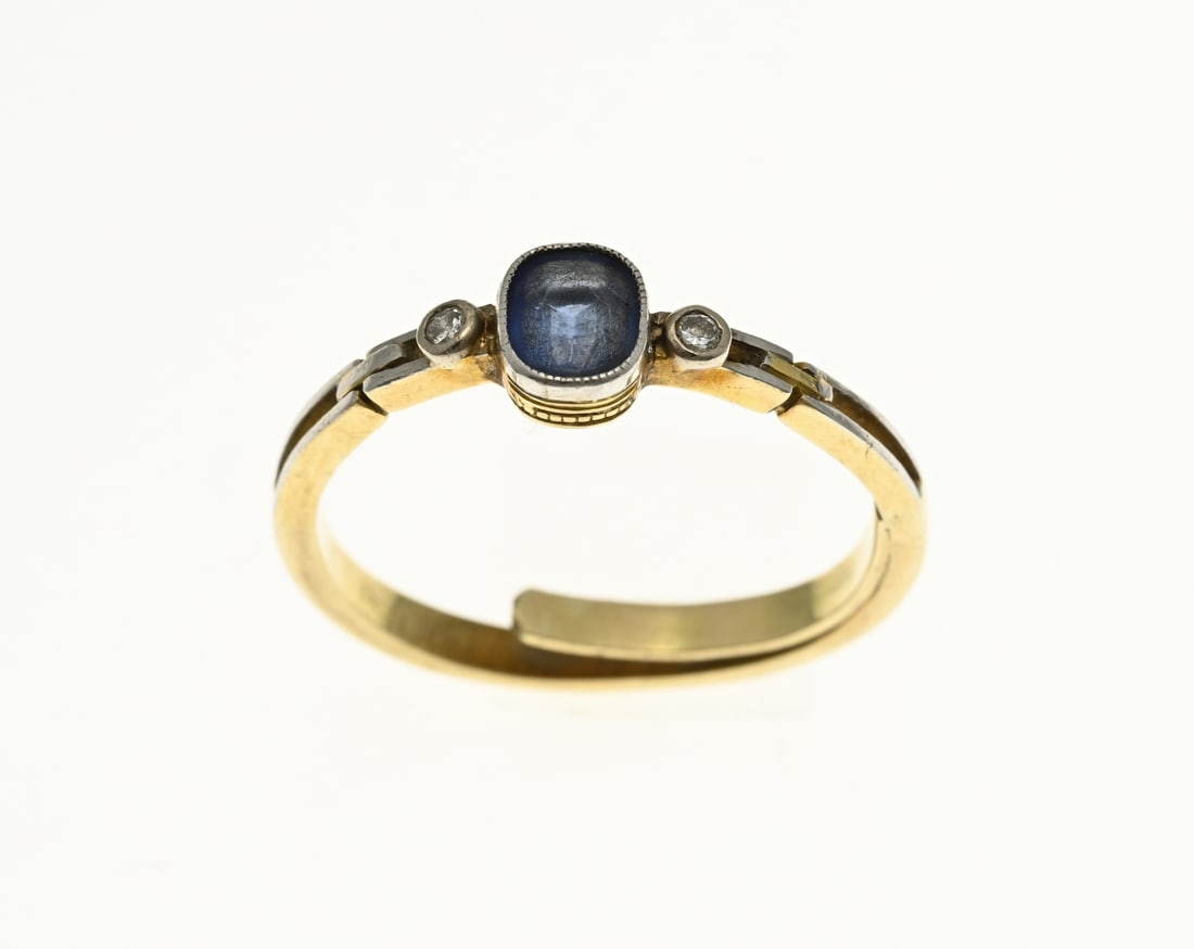 Gold ring with sapphire and diamond: Yellow gold ring, 585/000, with sapphire and diamonds. Ring with an oval setting set with a faceted blue sapphire. There is a small diamond on the sides of the sapphire. The openwork top is partly