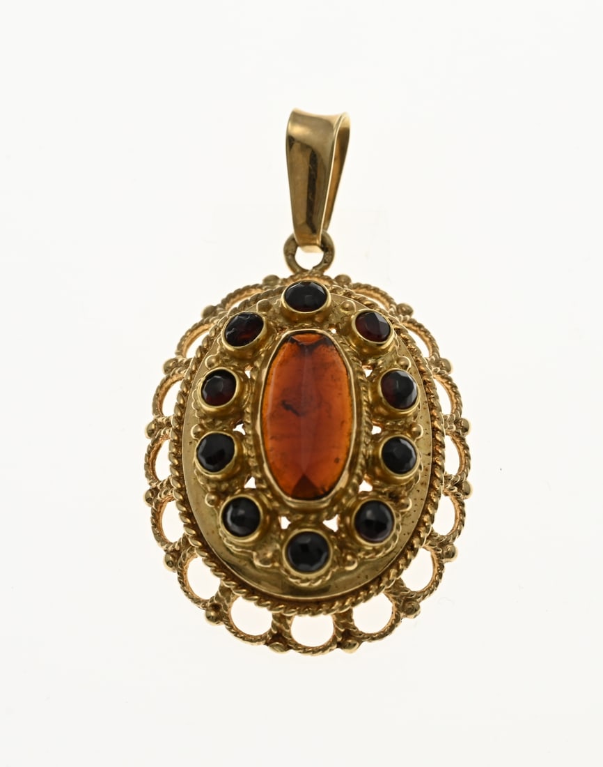 Gold pendant with garnet: Yellow gold pendant, 585/000, with garnet. Oval pendant with twisted work and a rosette with 11 facetted garnets. 21x37 mm. approx. 6.2 grams. One stone damaged. In good condition.