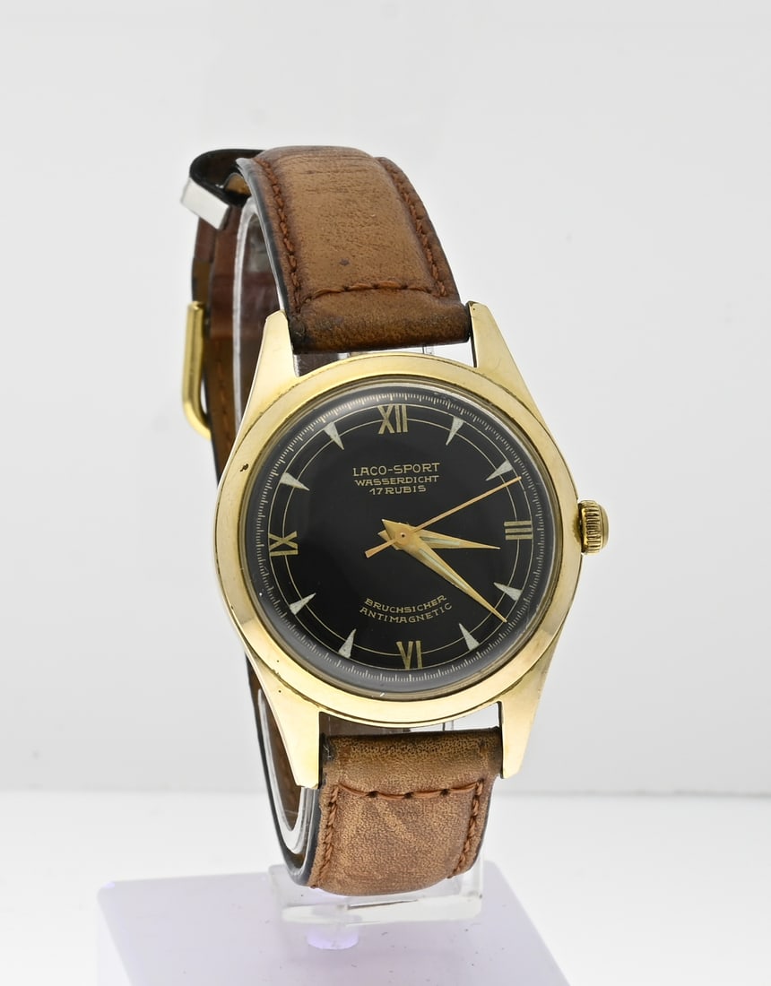 Laco watch, vintage: Vintage Laco watch, Laco Sport, Bruchsicher antimagnetic, mechanical, provided with a black dial. ø case 32 mm. The watch has a brown leather strap. Working. In good condition.