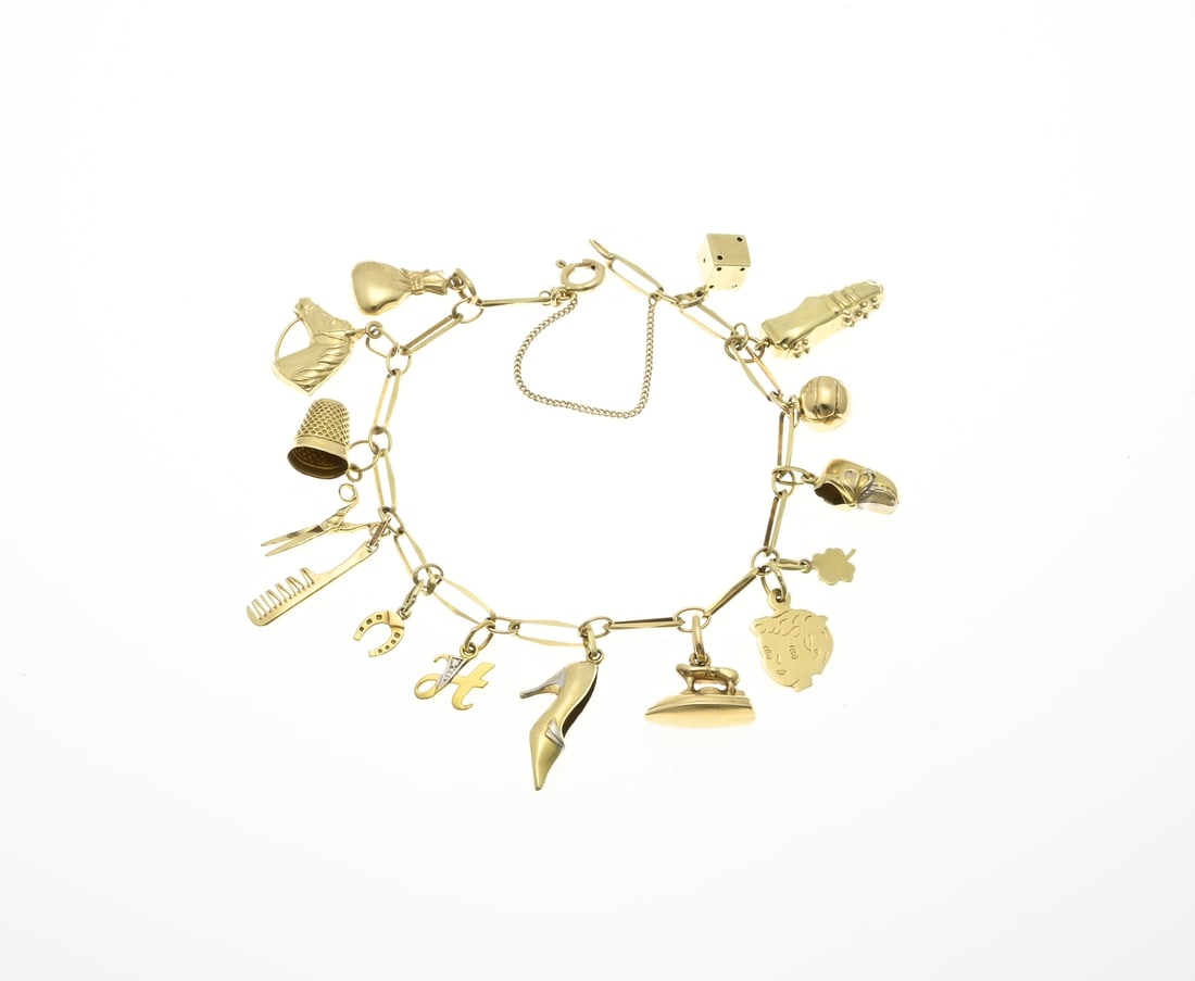 Gold cfe bracelet with charms: Yellow gold close for ever bracelet, 585/000, with 14 charms. Fine bracelet with various charms, including a ball, clover, shoe, scissors, comb, horse, football shoe and a child's head. The bracelet