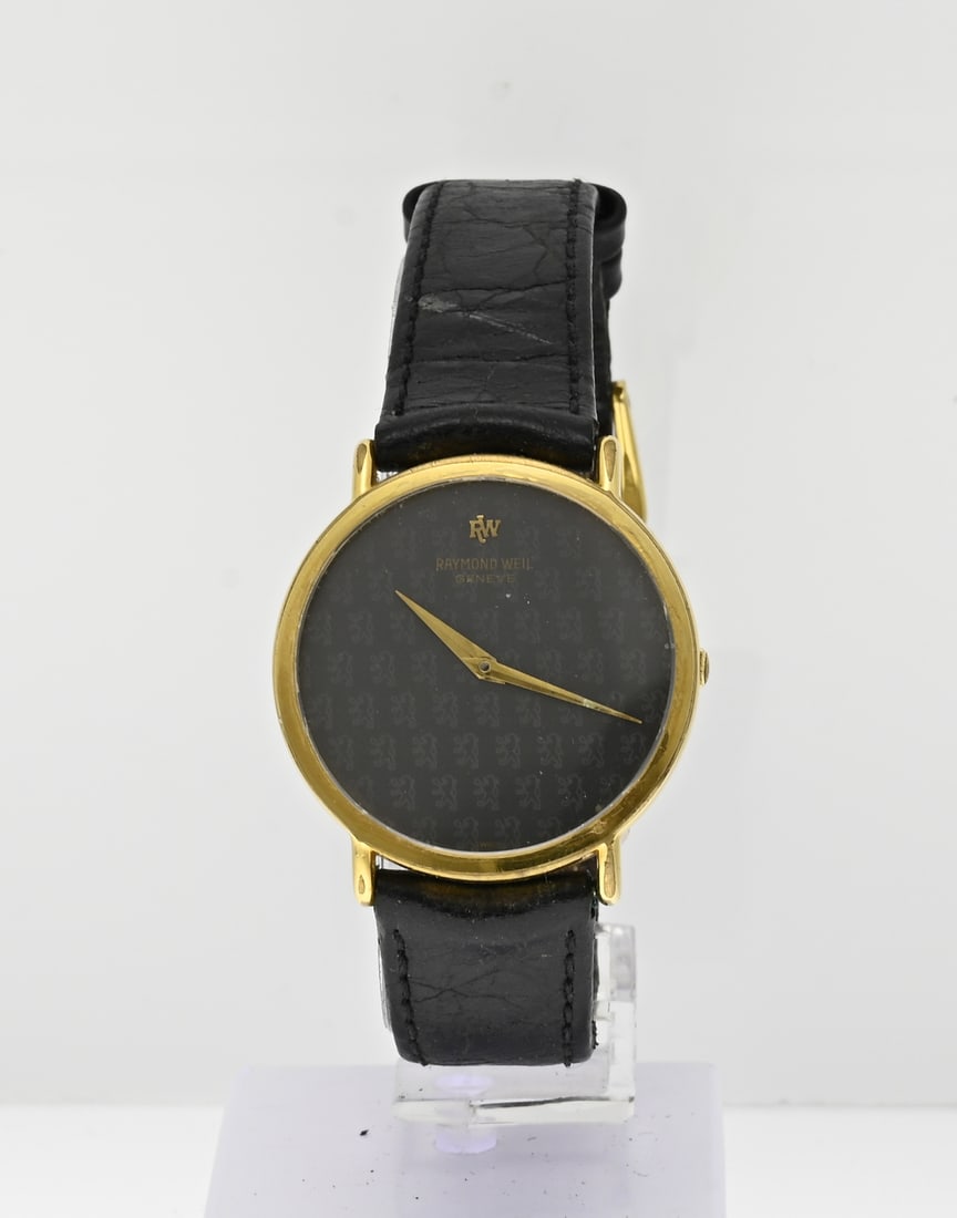 Raymond Weil double with black belt: Raymond Weil watch, gold plated, provided with a round case with a grey worked dial. With black leather strap. ø case 31 mm. Quartz. Working. ref. no.: 5508. Case somewhat damaged otherwise in good