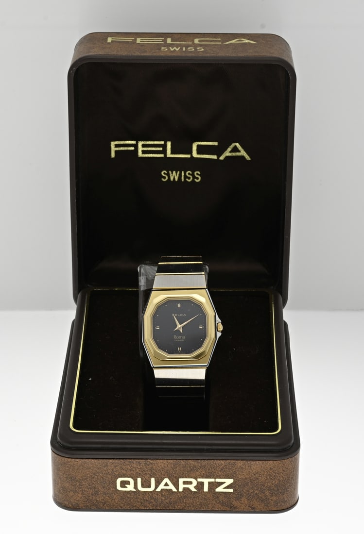 Felca watch: Vintage ladies watch, Felca Roma, gold plated rectangular contoured case with a black dial and a steel strap with gold plating. Quartz. Case width 26 mm. length 18 cm. In very good condition with box