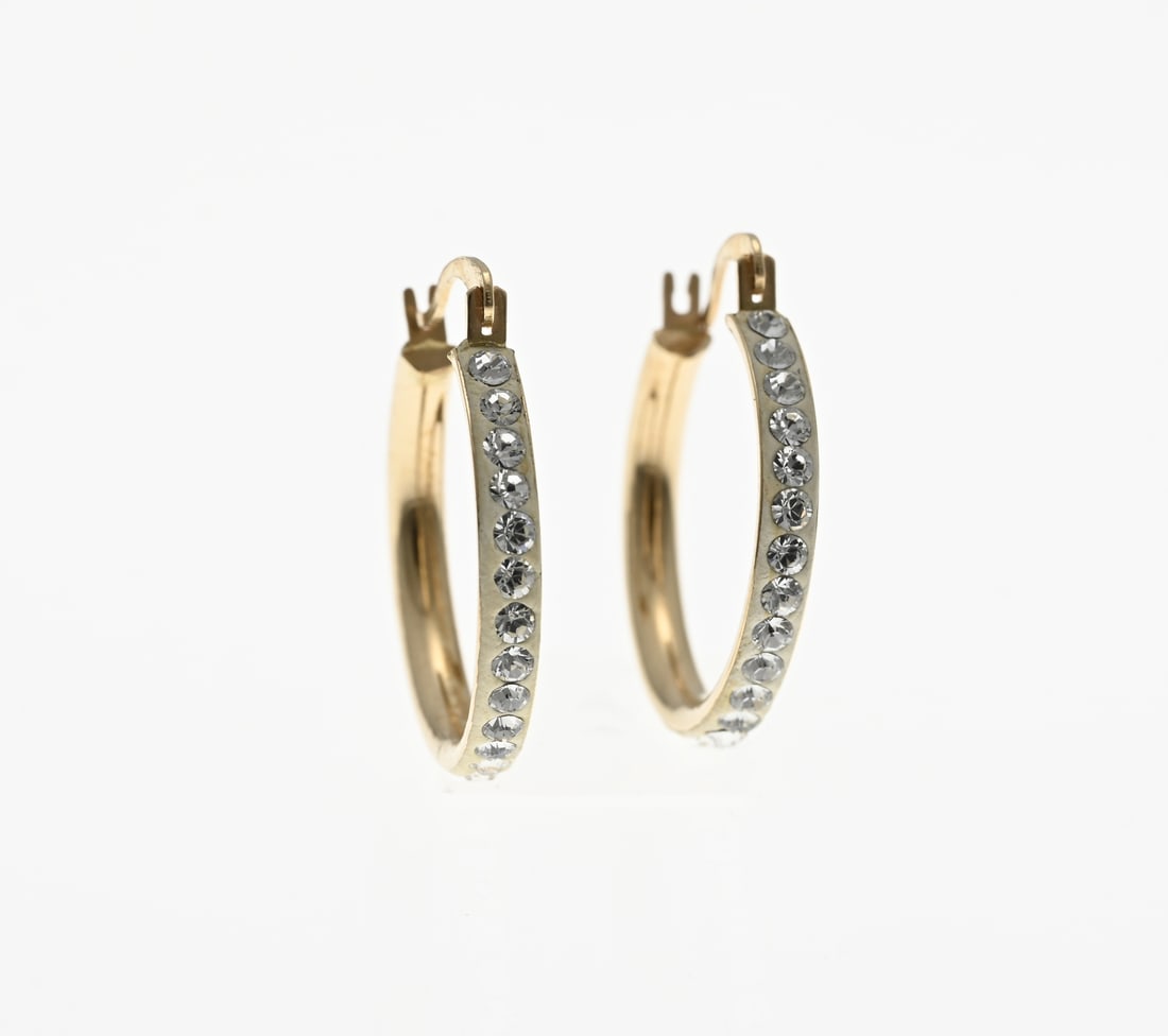 Gold earrings with zirconias: Yellow gold earrings, 585/000, with zirconia. Earrings with a semicircular tube set with zirconia in a matted tube. Width 2.4 mm. ø earring 17.5 mm. Total approx. 1.1 grams. In good condition.