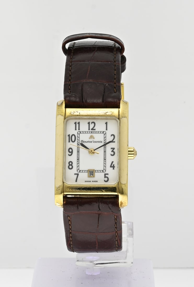 Maurice Lacroix watch: Maurice Lacroix classic watch, lady, with a goldplated rectangular case with date display. With sapphire glass. The watch has a brown leather strap. Width 23 mm. Quartz, working. ref. no.: 79755
