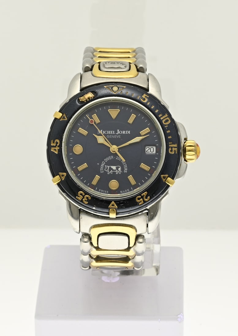 Michel Jorde watch: Steel watch, Michel Jorde, Geneve, Ethno Diver- 200 meters, Quartz. Equipped with a black bezel and a dark blue dial. The watch has gold-plated details. ø case 34 mm. ref. 1991/DJ. In good condition.