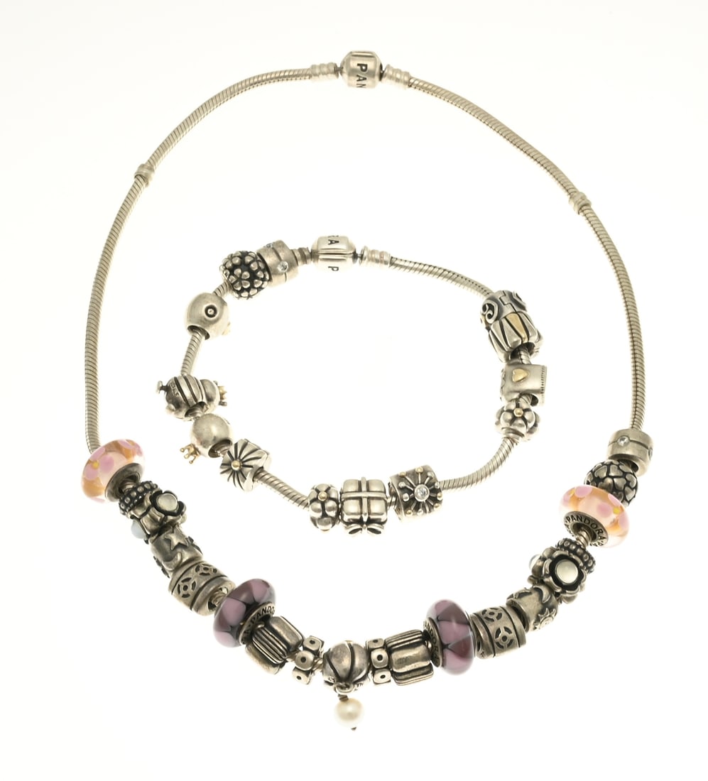 Pandora bracelet and necklace: Silver Pandora bracelet and necklace with charms, 925/000. Bracelet with a Pandora lock and 13 charms of which 10 with a gold element, Length 21 cm. And a necklace with Pandora lock and 19 charms of