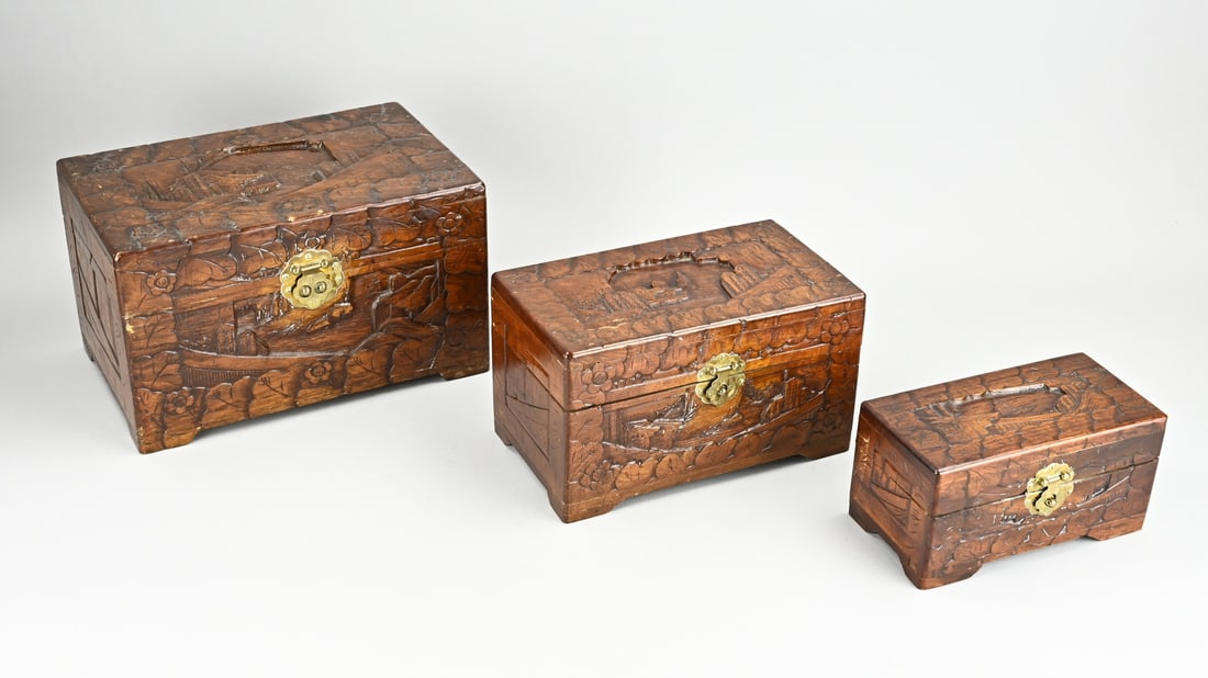 3 Small camphor chests: Three small Indonesian carved camphor wood boxes with landscape decor. Size: 20 - 30 cm. In good condition.
