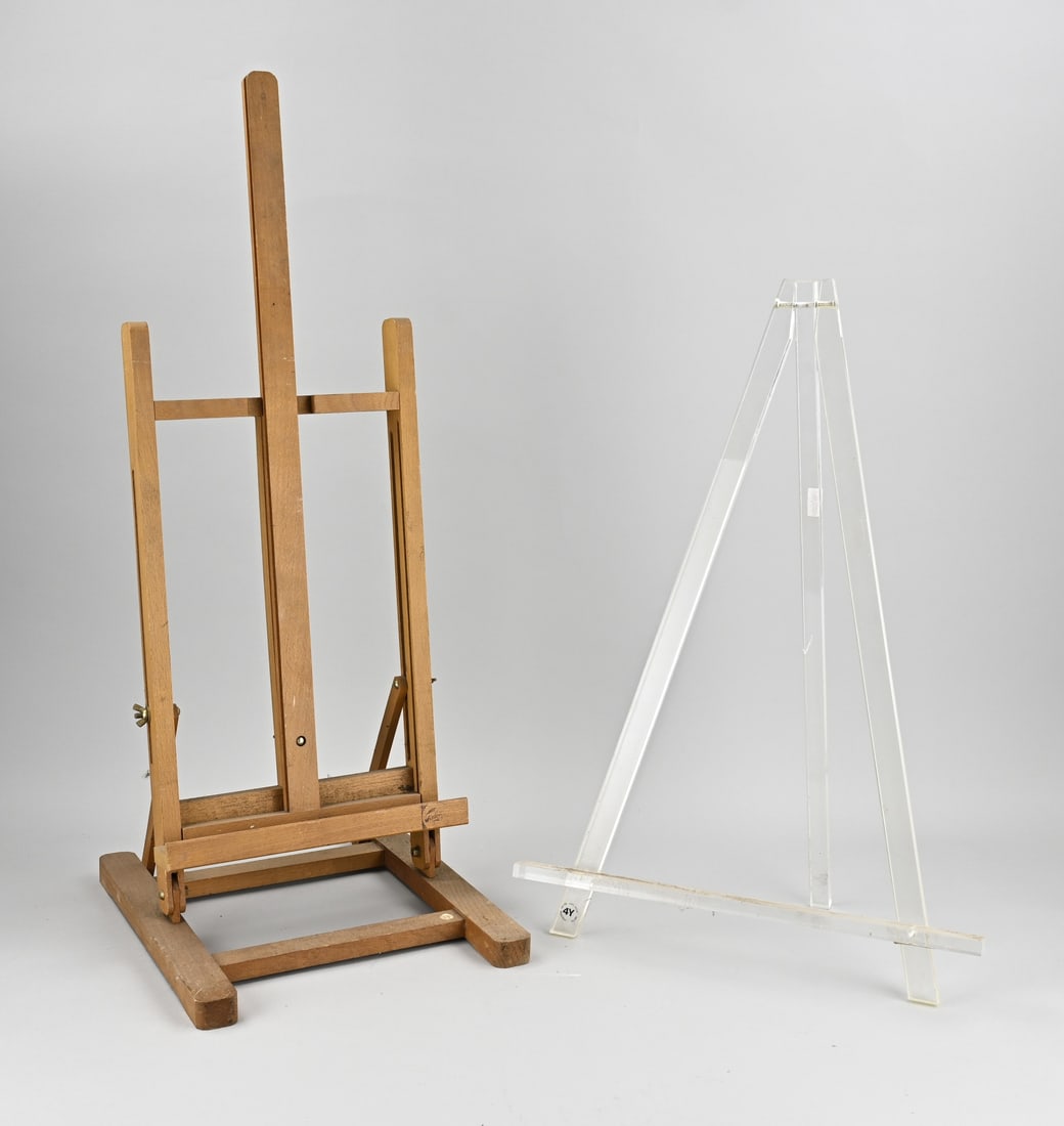 2x Easel (pvc + wood): 2x Easel. 21st Century. 1x Modern (pvc). 1x Beechwood. Size: 60 - 70 cm. In good condition.