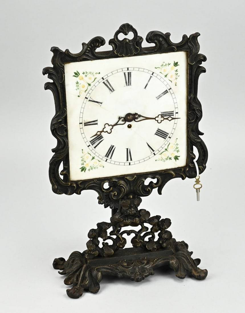 Antique night clock, 1880: Antique cast iron night light clock with candle holder. Circa 1880. Hairline crack in glass dial, otherwise good. Size: 34 cm. In reasonable/good condition.