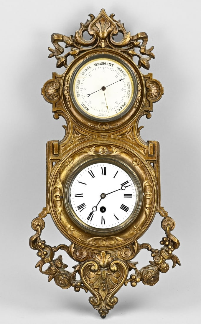 Barometer with clock, 1890: Antique composition metal barometer with eight-day silent clockwork. With Dutch print. Circa 1890. Size: 49 cm. In good condition.