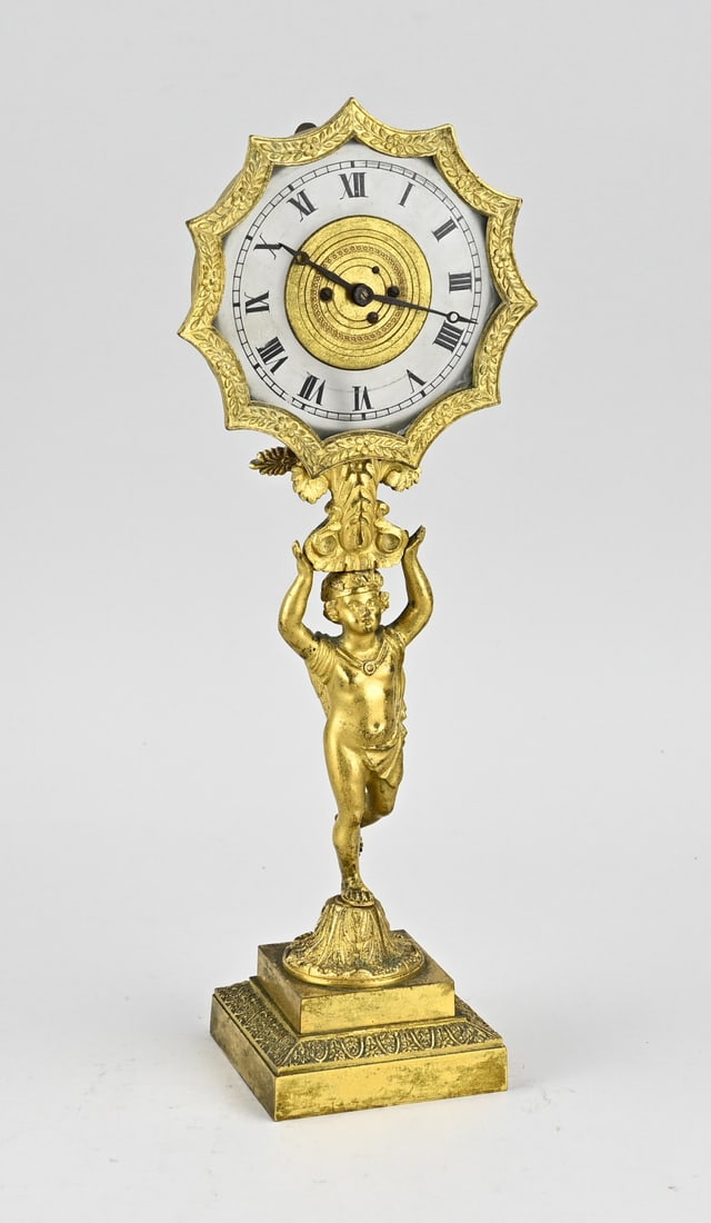 French bell bearer: Rare fire-gilt French bell-bearer/bronze night-light mantel clock, with transparent glass dial. Circa 1820. Dimensions: H 33 cm. In rare good + working condition.