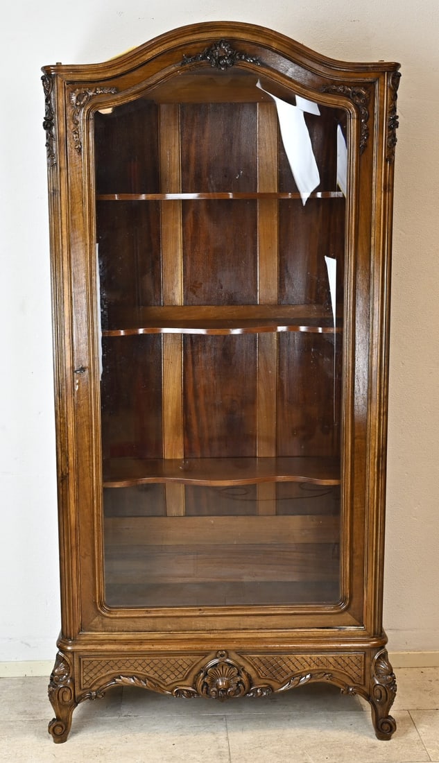 1-door cabinet with glass, H 217 cm.: Walnut one-door display cabinet with carvings on the corners and door. There is a drawer at the bottom of the foot. The glass in the door is facet cut. France. Circa 1860. Dimensions: 217 x 105 x 36