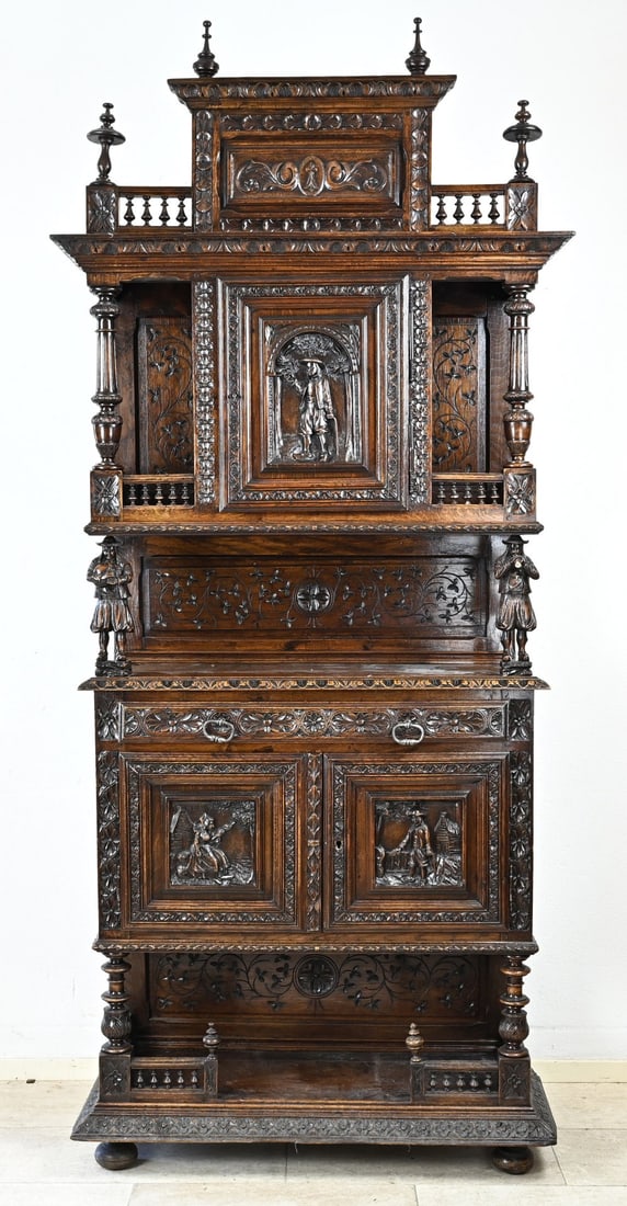 Breton cabinet, 1870: 19th century chestnut Breton cabinet with beautiful carved panels, musicians and fencing. France. Circa 1870. Dimensions: 230 x 100 x 45 cm. In very good condition.