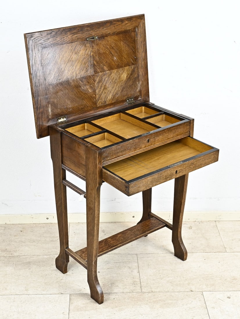 Sewing table, 1900: Antique oak sewing table with drawer, compartments and star intarsia. Germany. Circa 1900. Dimensions: 79 x 64 x 44 cm. In good condition.