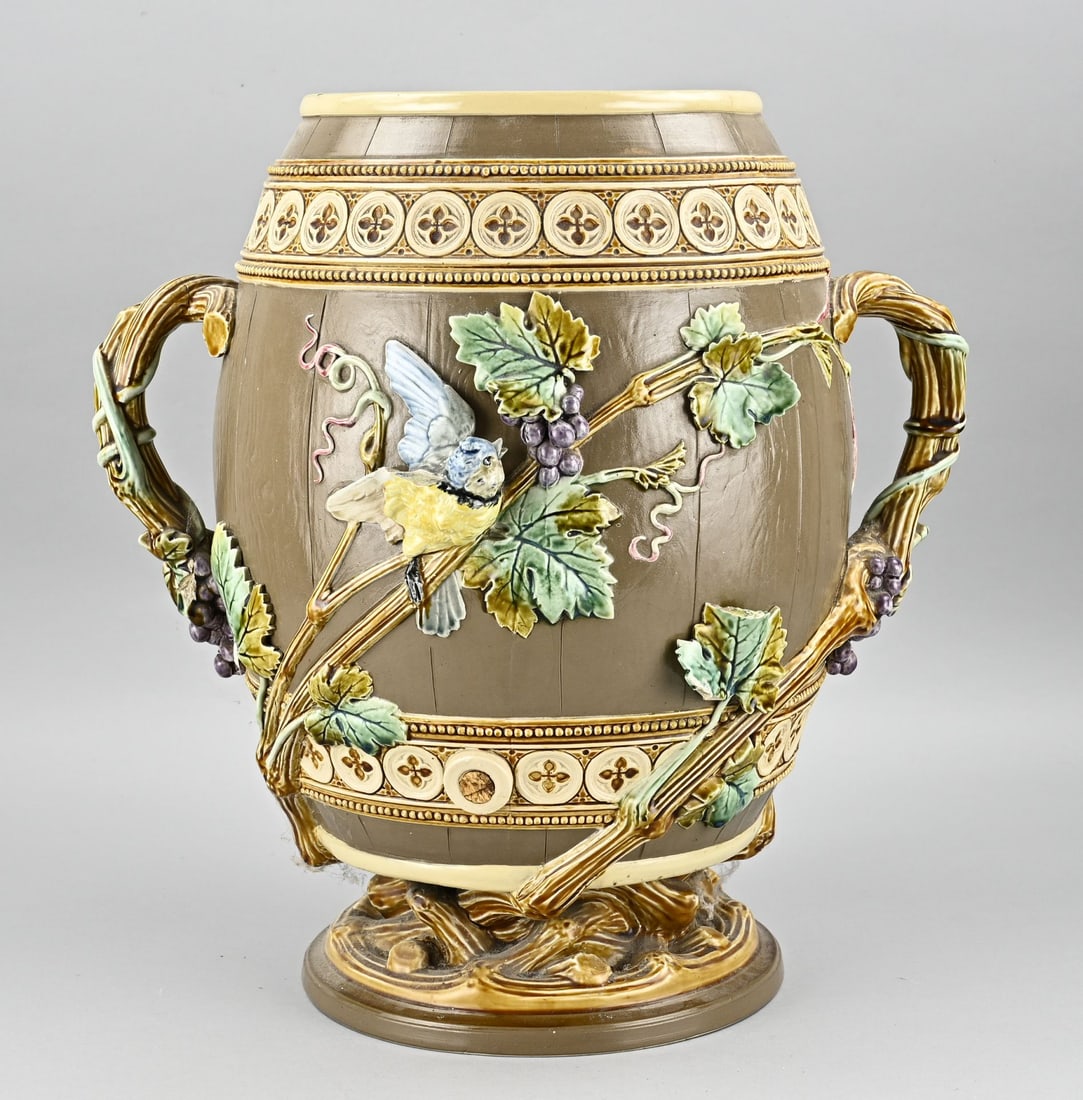 Mettlach drinks barrel: Large German antique Mettlach majolica drink barrel. Circa 1900. With grapevines/bird decoration. Faucet is missing. Lid is missing. Some damage. Size: 42 cm. In fair condition.