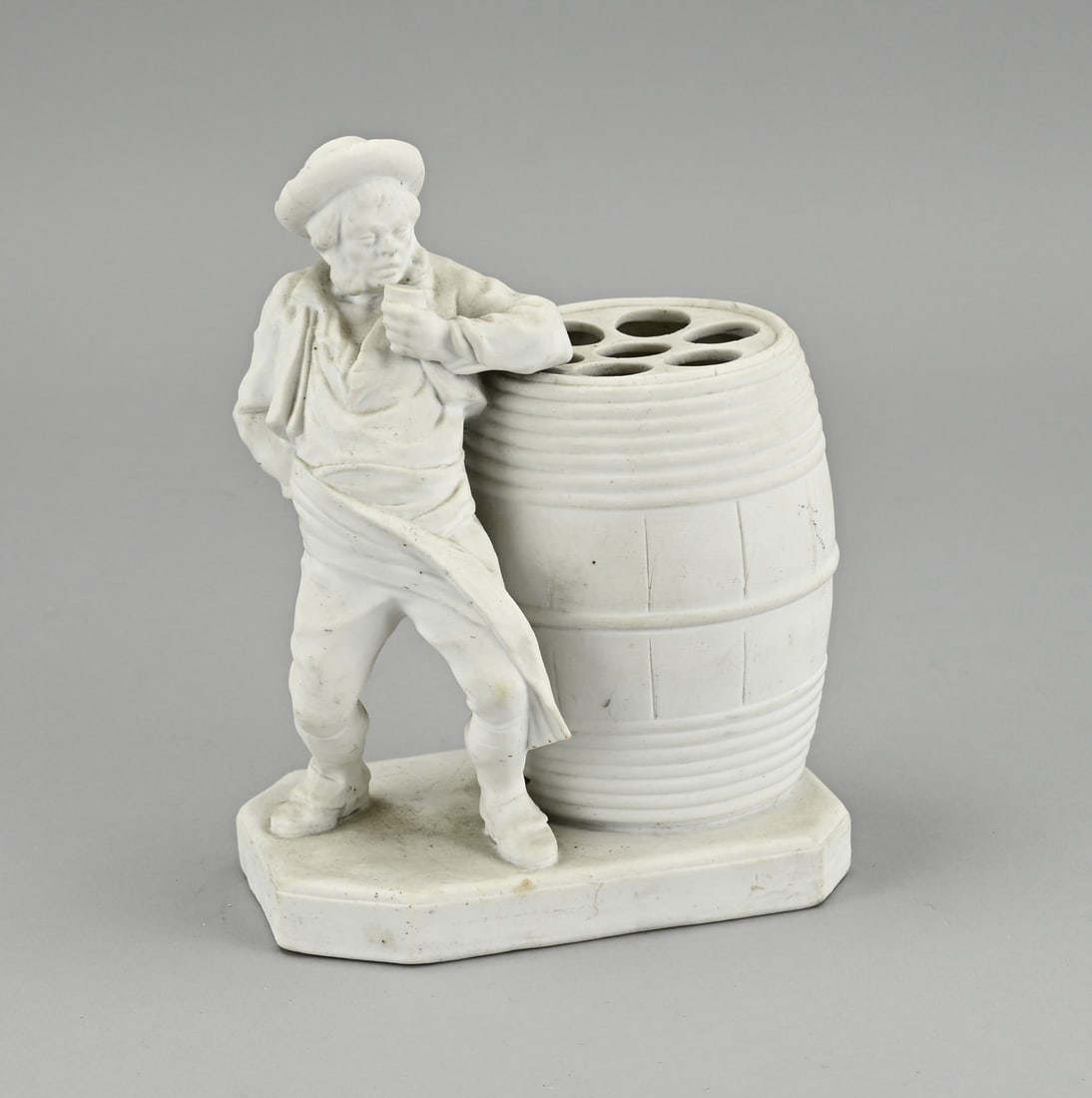 Cigar holder, H 18 cm.: Antique biscuit porcelain cigar holder with beer barrel and drunkard. Marked ED 136. Size: 17 cm. In good condition.